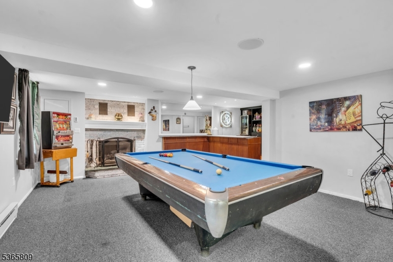 9 Mueller Lane Washington, NJ 07882 - Photo 4 of 45 a room with pool table and a flat screen tv