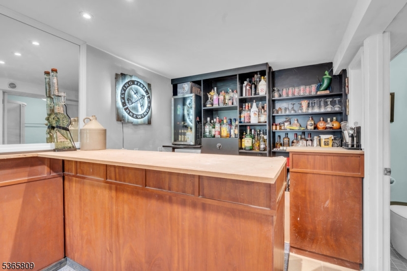 9 Mueller Lane Washington, NJ 07882 - Photo 5 of 45 a living room with stainless steel appliances lots of books and furniture