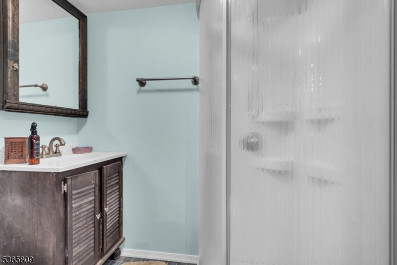 9 Mueller Lane Washington, NJ 07882 - Photo 7 of 45 a bathroom with a sink and a mirror