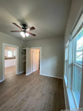 wooden floor in an empty room with a window