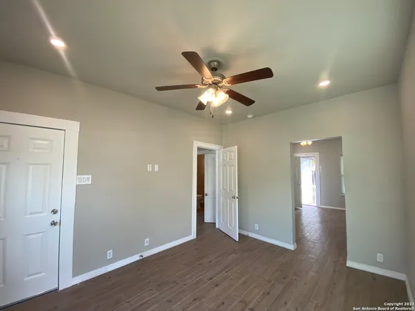 a view of an empty room and wooden floor