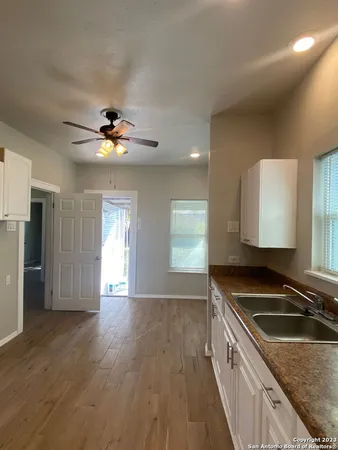 a kitchen with granite countertop a sink stainless steel appliances a counter space and a window