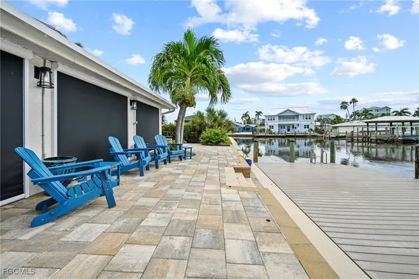 a view of swimming pool with outdoor seating and plants