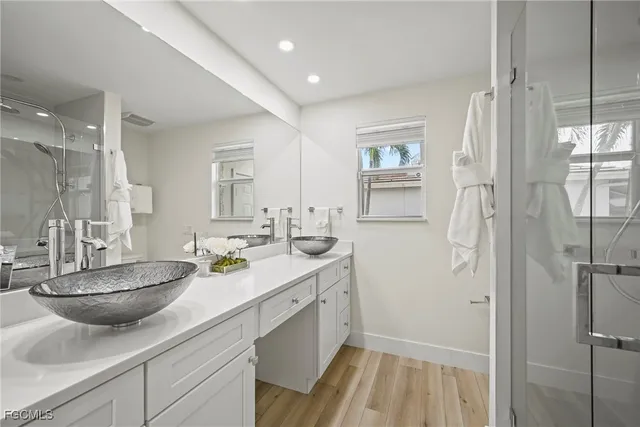 a bathroom with a sink double vanity granite tub and shower