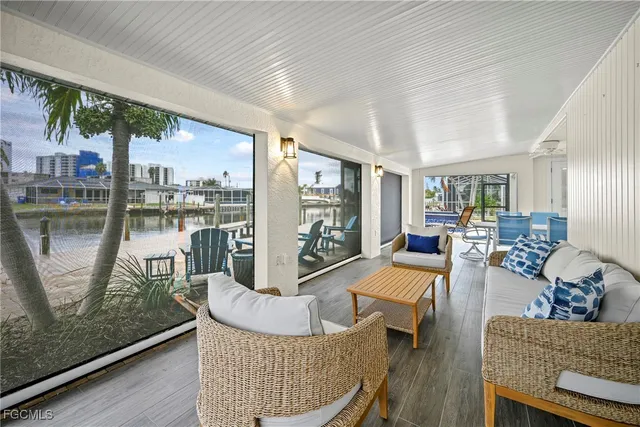 a living room with furniture and a floor to ceiling window
