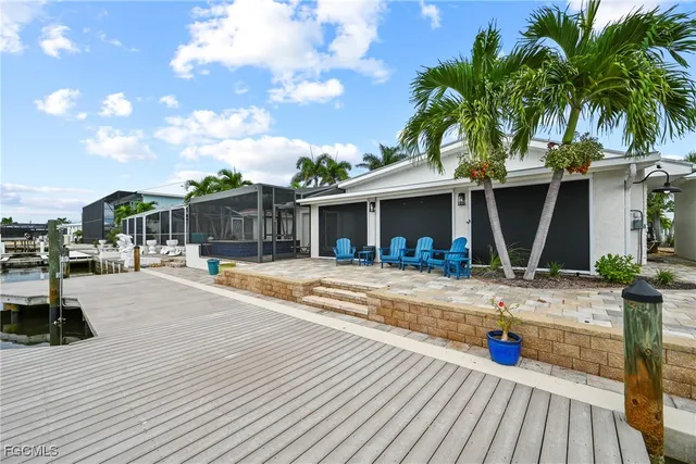 a view of a house with backyard and sitting area