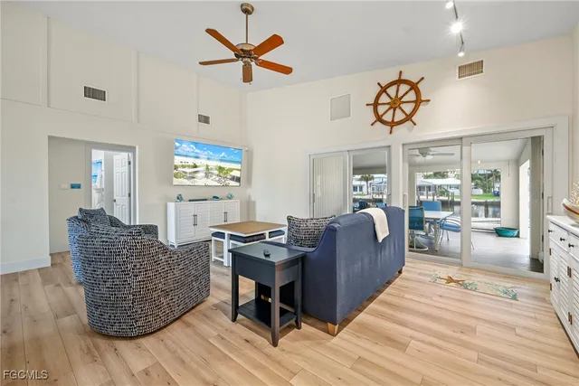 a living room with furniture a wooden floor and window