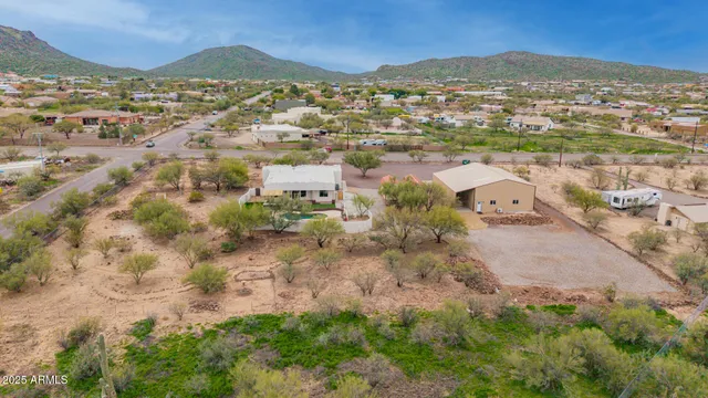 a spacious bathroom with a granite countertop sink mirror and a toilet
