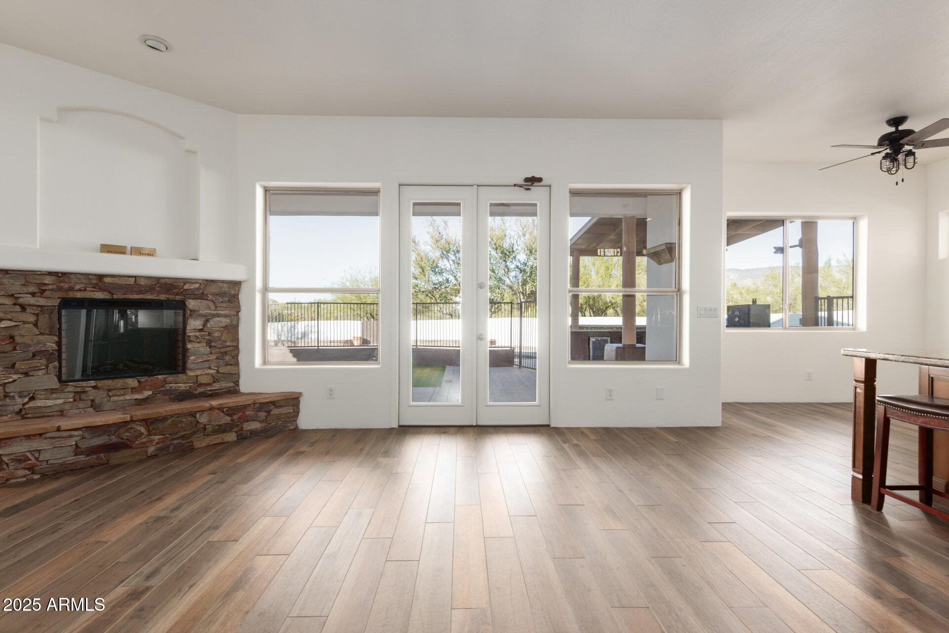1540 East Circle Mountain Road New River, AZ 85087 - Photo 30 of 65 a view of room with wooden floor and fireplace