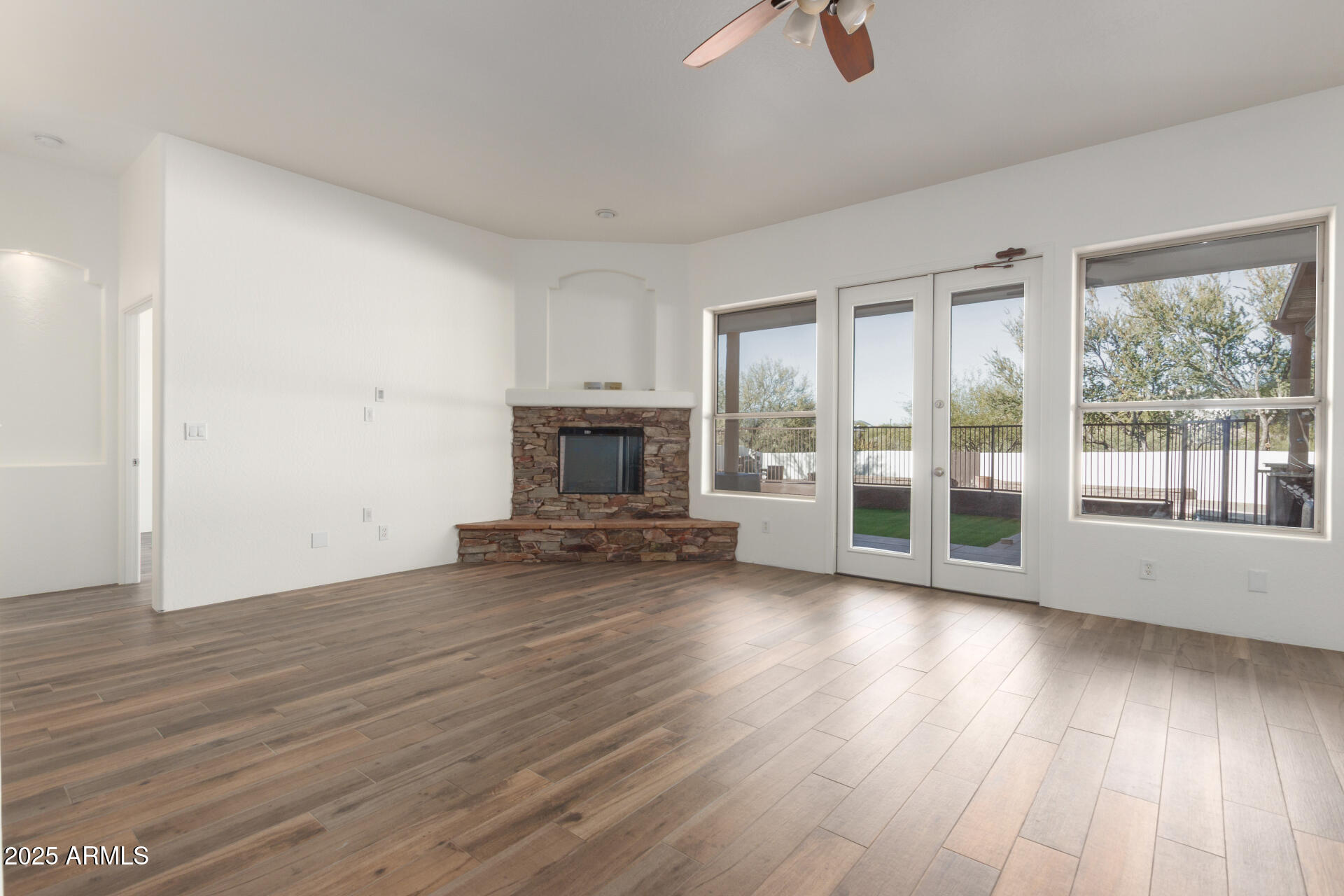 1540 East Circle Mountain Road New River, AZ 85087 - Photo 31 of 65 a view of a livingroom with wooden floor and a fireplace