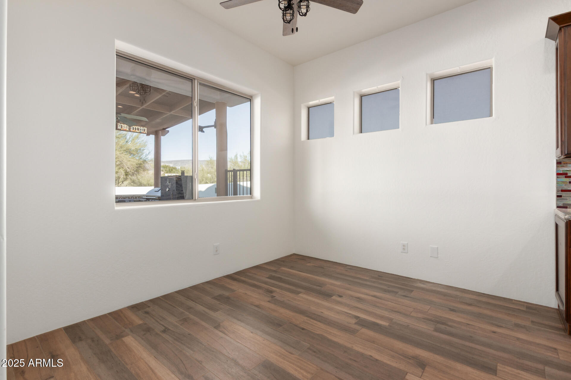 1540 East Circle Mountain Road New River, AZ 85087 - Photo 36 of 65 a view of empty room with wooden floor and fan