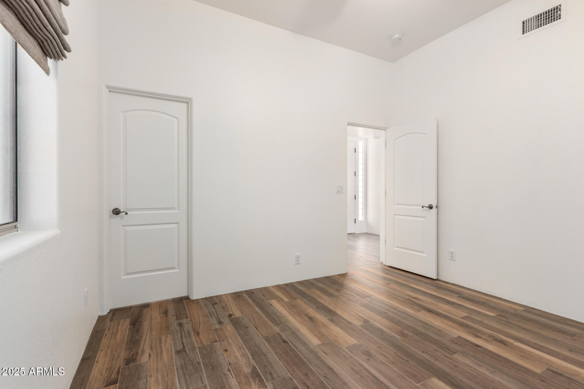 1540 East Circle Mountain Road New River, AZ 85087 - Photo 45 of 65 an empty room with wooden floor and closet