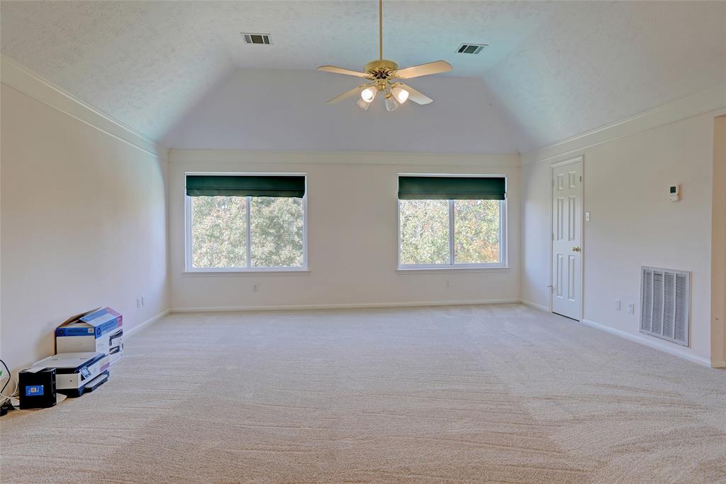 2905 Wyndham Lane Richardson, TX 75082 - Photo 18 of 27 an empty room with windows and fan