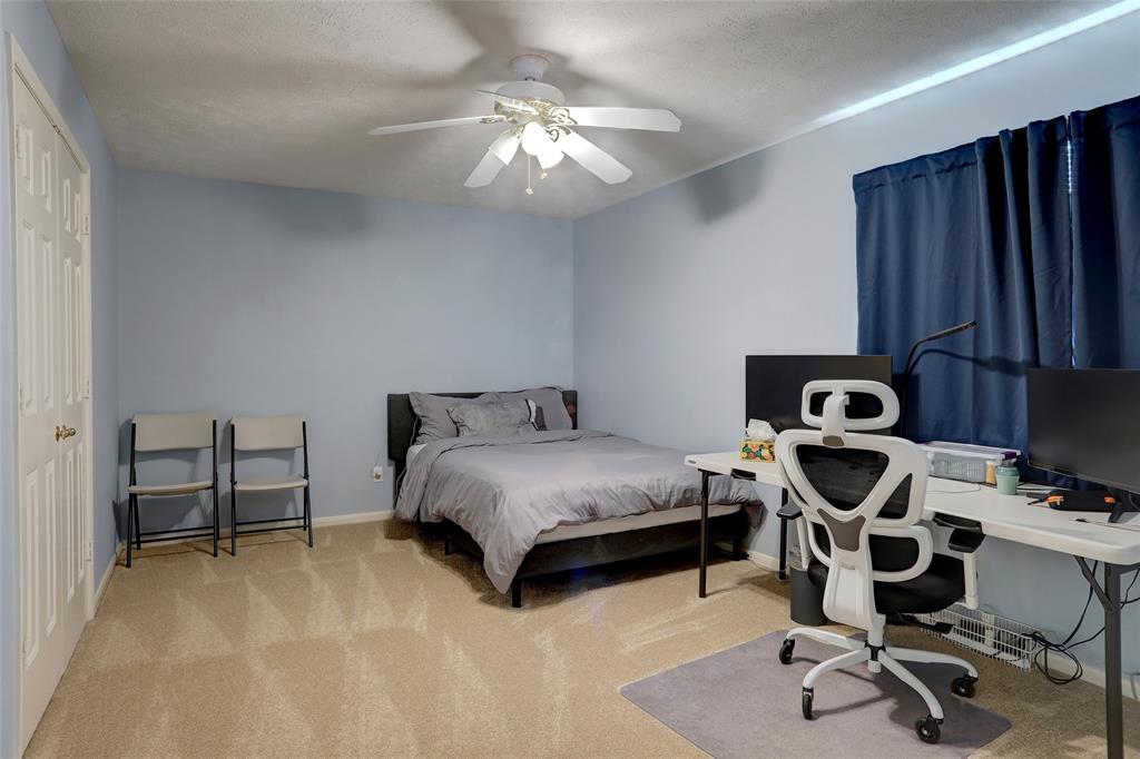 2905 Wyndham Lane Richardson, TX 75082 - Photo 22 of 27 a bedroom with a bed and a chair in it