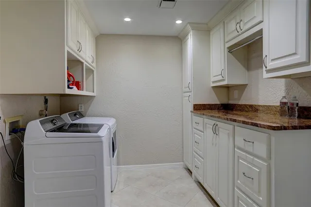 a kitchen with granite countertop a sink stove and cabinets