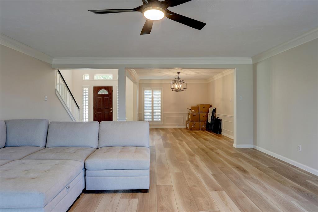 2905 Wyndham Lane Richardson, TX 75082 - Photo 6 of 27 a living room with furniture and a chandelier
