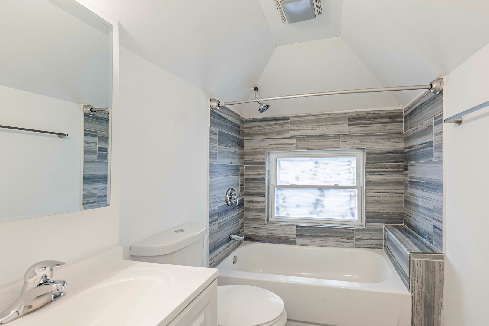 2038 East 73rd Street Chicago, IL 60649 - Photo 14 of 28 a bathroom with a sink and bathtub with window