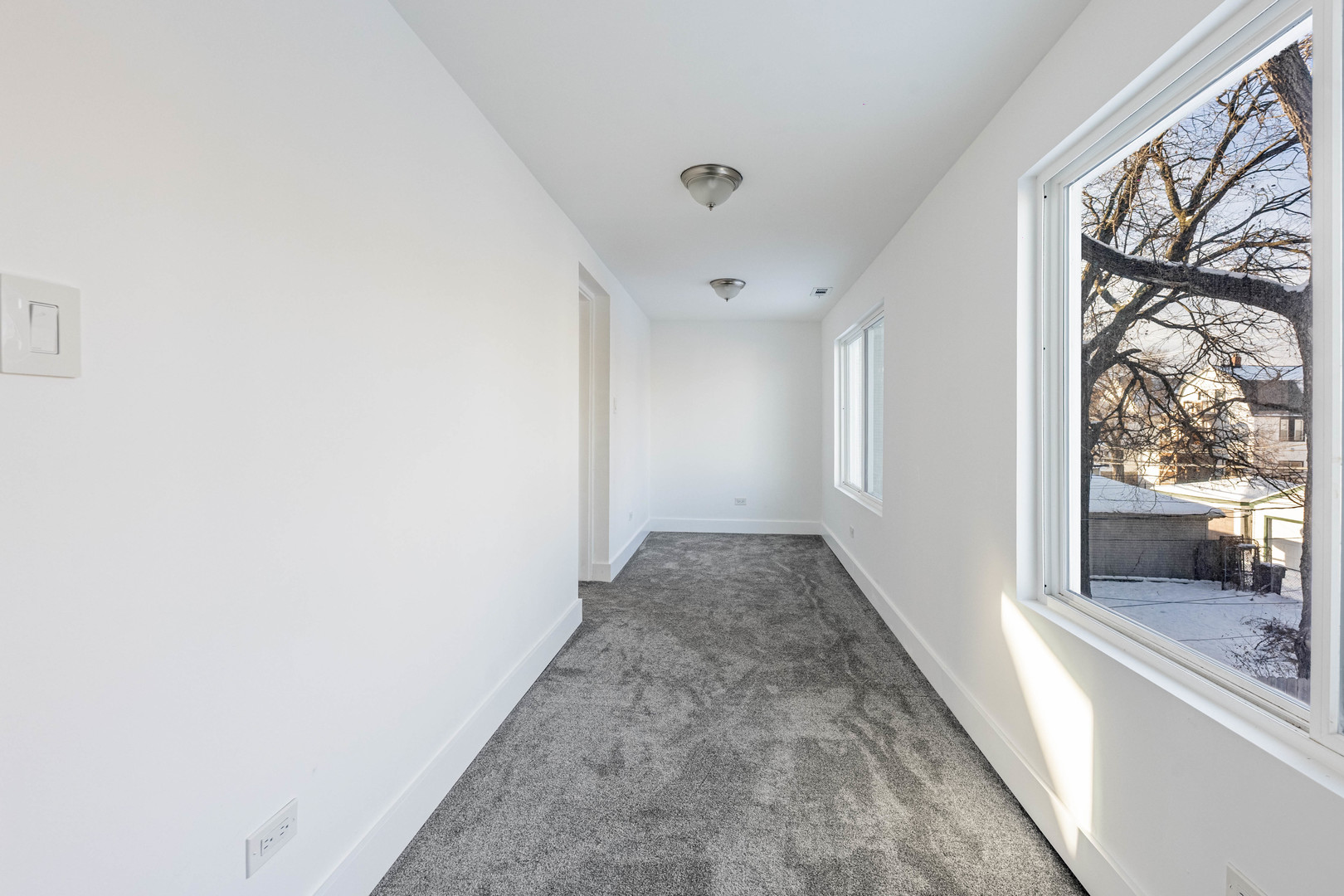 2038 East 73rd Street Chicago, IL 60649 - Photo 17 of 28 a view of a hallway with wooden floor and a living room