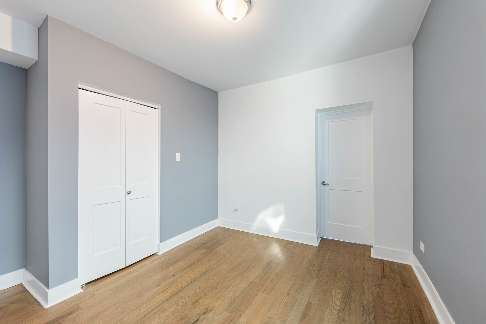 2038 East 73rd Street Chicago, IL 60649 - Photo 22 of 28 a view of an empty room with wooden floor