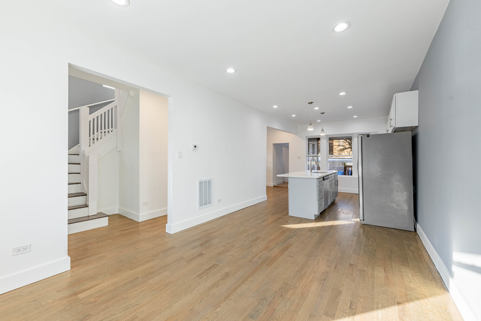2038 East 73rd Street Chicago, IL 60649 - Photo 4 of 28 a view of a kitchen with a sink and wooden floor