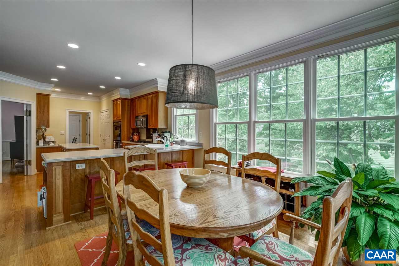 3465 Darby Road Keswick, VA 22947 - Photo 17 of 48 a dining room with furniture a chandelier and wooden floor