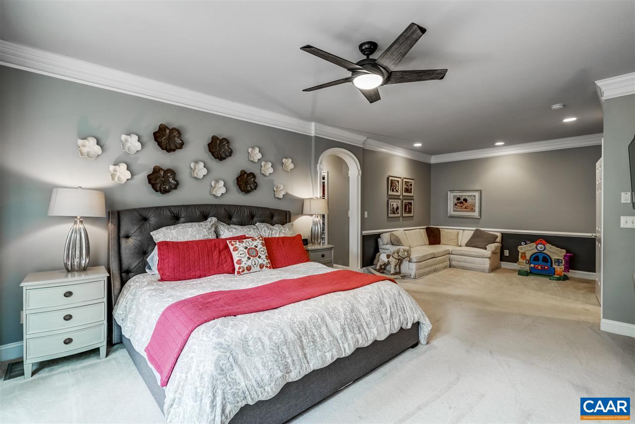 3465 Darby Road Keswick, VA 22947 - Photo 21 of 48 a bedroom with a large bed and a chandelier