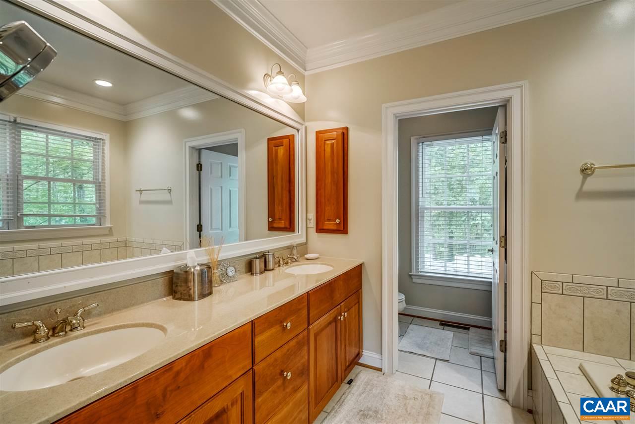 3465 Darby Road Keswick, VA 22947 - Photo 25 of 48 a spacious bathroom with a double vanity sink a mirror and a bathtub