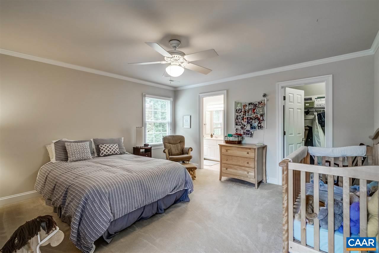3465 Darby Road Keswick, VA 22947 - Photo 32 of 48 a bedroom with a bed and a chandelier