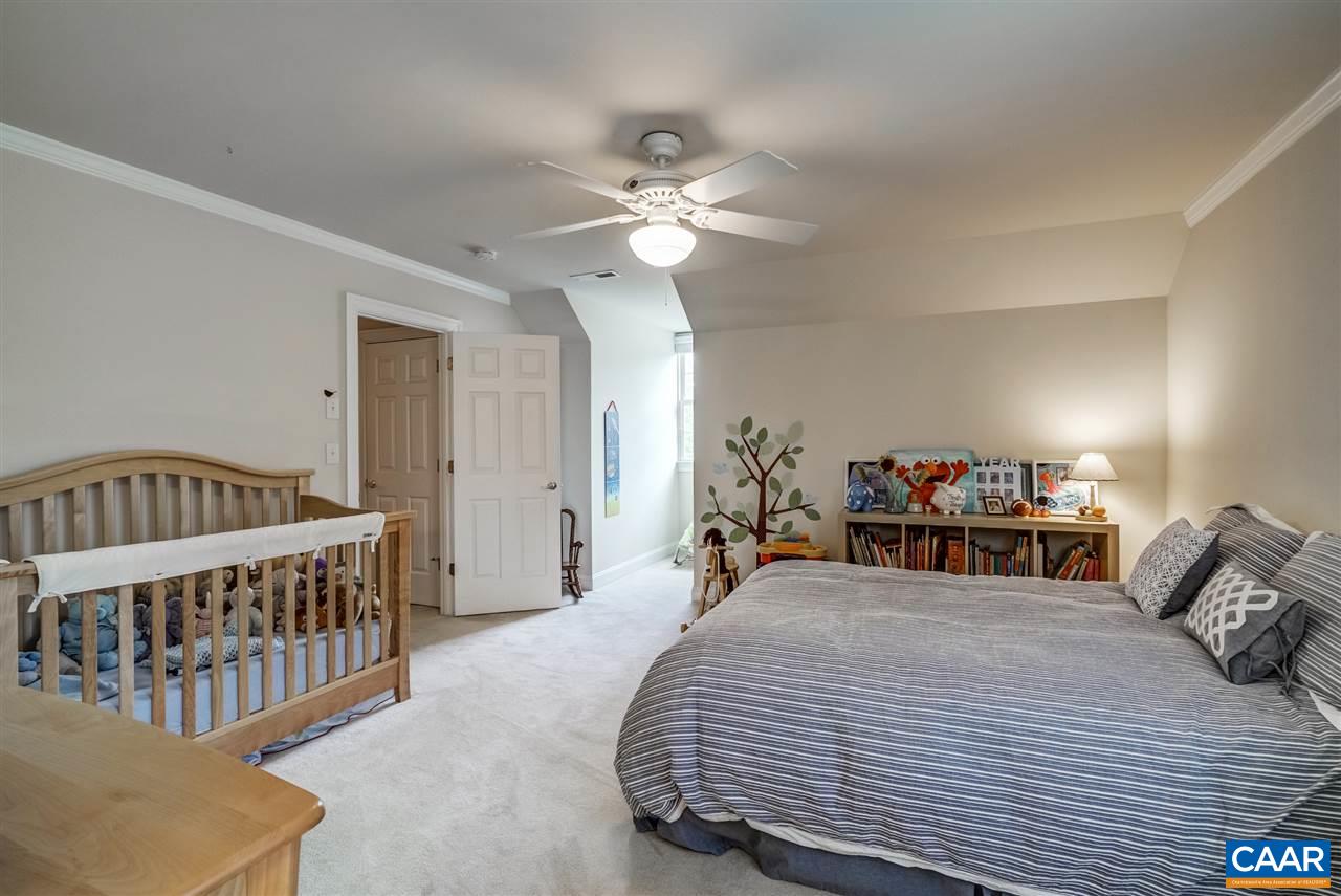3465 Darby Road Keswick, VA 22947 - Photo 33 of 48 a bedroom with a bed and a chandelier