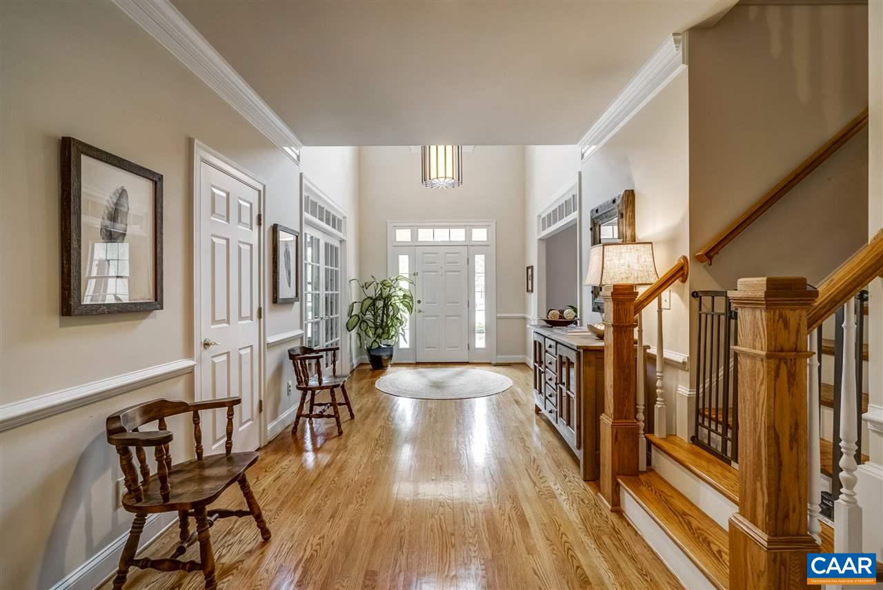 3465 Darby Road Keswick, VA 22947 - Photo 9 of 48 a view of a hallway with wooden floor and furniture