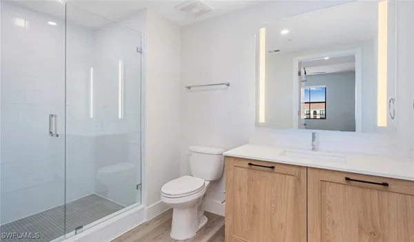 a view of a small space with wooden floor and a window