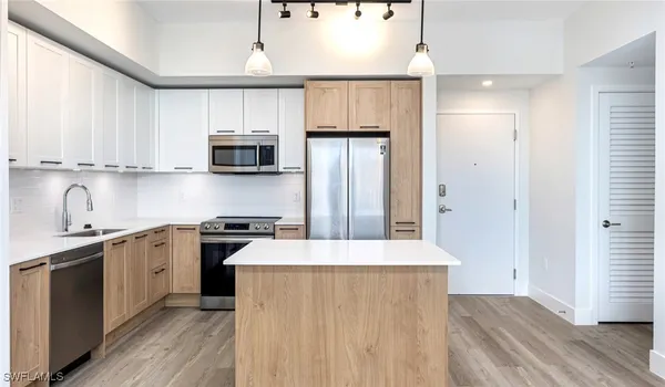 a kitchen with stainless steel appliances a refrigerator stove and sink