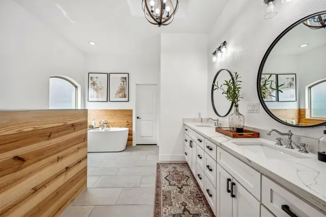 a bathroom with a double vanity sink mirror and toilet