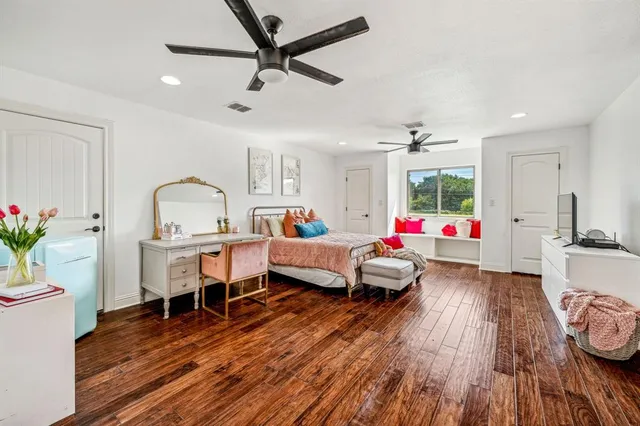 a playing room with furniture and a wooden floor