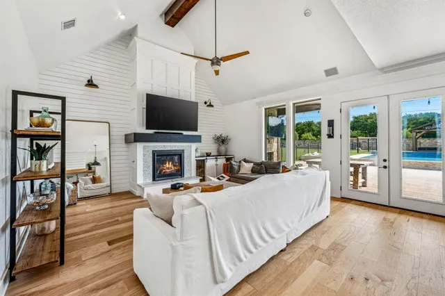 a living room with furniture fireplace and flat screen tv