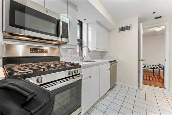 a kitchen with a stove and a microwave