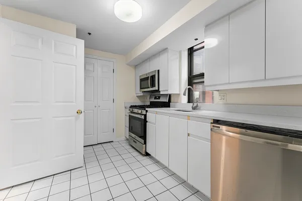 a kitchen with a sink and a stove top oven