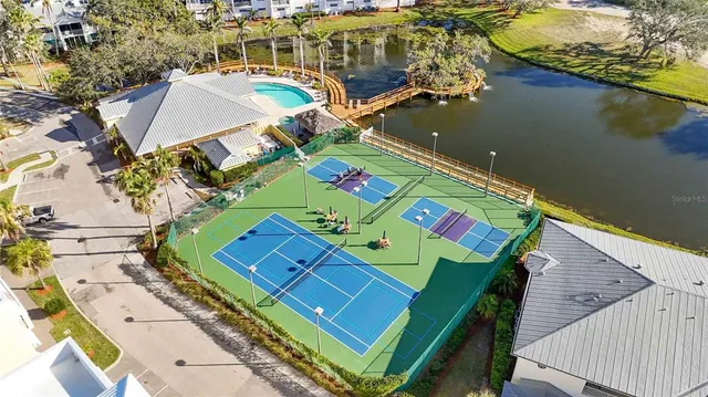 an aerial view of a pool patio lake and mountain view