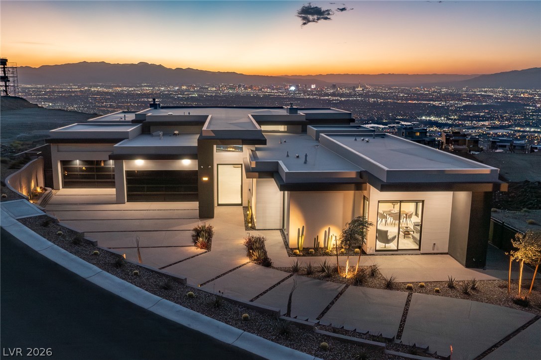 563 Grand Rim Drive Henderson, NV 89012 - Photo 40 of 70 Perched on a hill, this modern residence offers mesmerizing city light views stretching to the horizon.