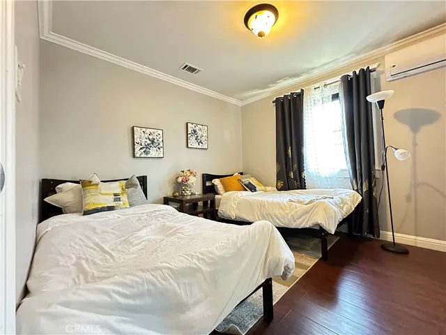 a bedroom with two beds and a large window