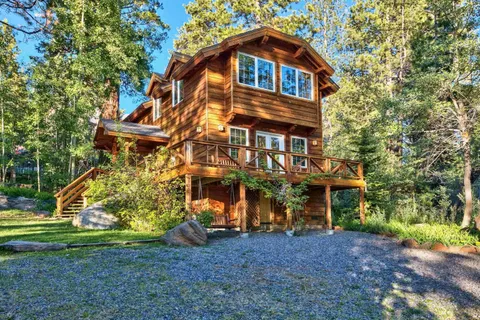 a view of a balcony with wooden floor and outdoor space