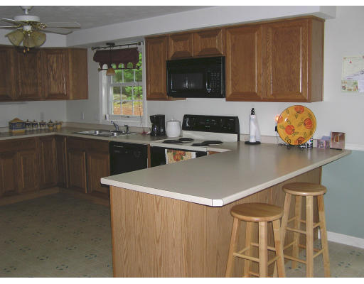 495 West Sturbridge Road East Brookfield, MA 01515 - Photo 3 of 13 a kitchen with a sink a stove and microwave