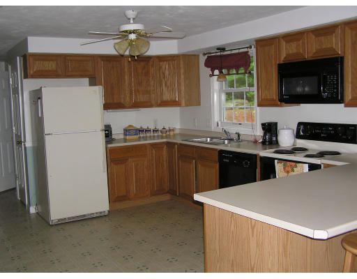 495 West Sturbridge Road East Brookfield, MA 01515 - Photo 7 of 13 a kitchen with stainless steel appliances a sink a stove a microwave a refrigerator a counter top space and cabinets