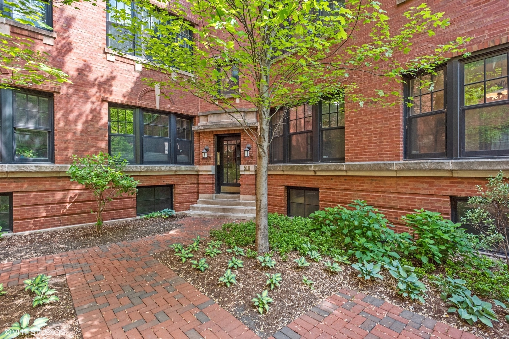 518 West Wrightwood Avenue, Unit 1E Chicago, IL 60614 - Photo 1 of 10 a front view of a house with garden