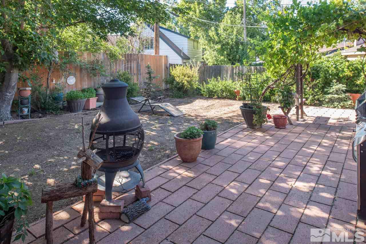 1490 O Farrell Street Reno, NV 89503 - Photo 14 of 15 a view of a patio with table and chairs potted plants and large tree
