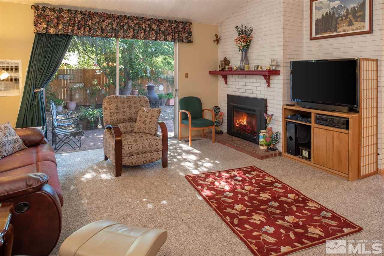 1490 O Farrell Street Reno, NV 89503 - Photo 3 of 15 a living room with furniture a flat screen tv and a fireplace