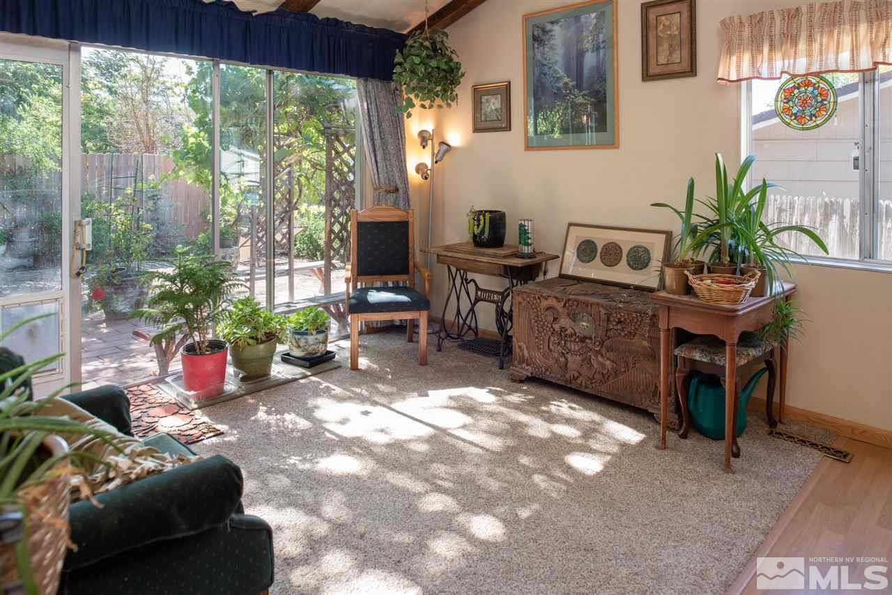1490 O Farrell Street Reno, NV 89503 - Photo 4 of 15 a living room with furniture a floor to ceiling window and potted plants