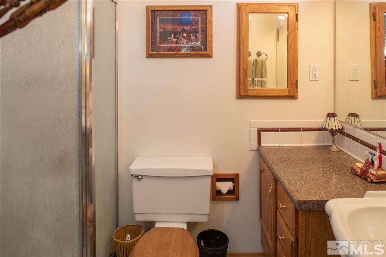 1490 O Farrell Street Reno, NV 89503 - Photo 10 of 15 a bathroom with a sink a toilet and mirror