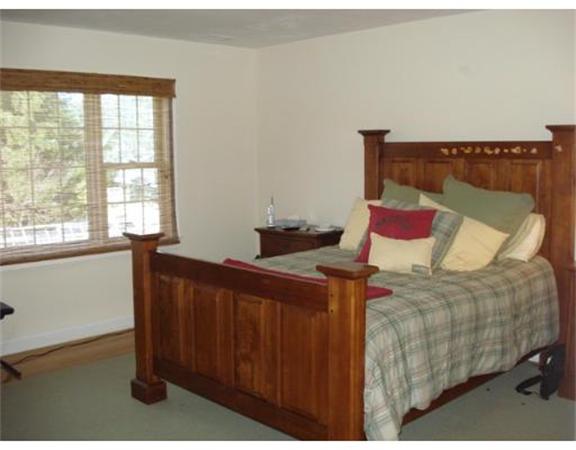 798 Worcester Street Wellesley, MA 02482 - Photo 12 of 20 a bed sitting in a bedroom next to a window