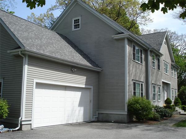 798 Worcester Street Wellesley, MA 02482 - Photo 2 of 20 a front view of a house with a yard and garage